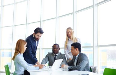 Effective team meeting with businesspeople collaborating with laptop