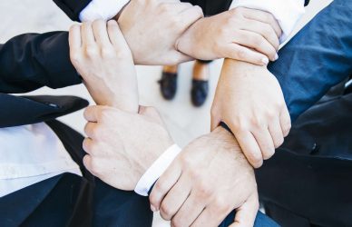 Team hands together showing strong company culture and teamwork collaboration